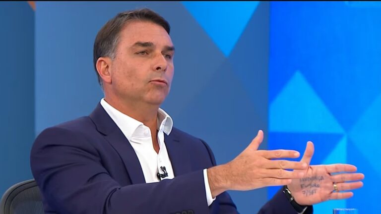 Flávio Bolsonaro leva anotações na mão durante sabatina na Globo